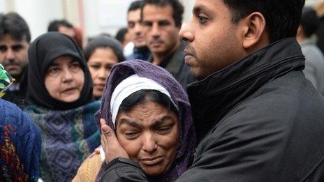 Fatima Khan, mother of Dr Abbas Khan 32, who died while being held in custody in Syria, is comforted by her son at a service