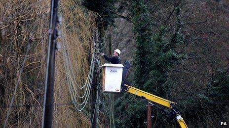 A workman repairing electricity lines near Reigate in Surrey after floods hit the area