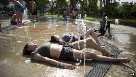 Children cool off in a fountain in Buenos Aires on 26 December, 2013