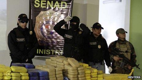 Police officers present evidence confiscated from an illegal airfield in a rural northern area used for drug trafficking on 23 August, 2013