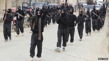 Fighters of the al-Qaeda linked Islamic State of Iraq and the Levant (Isis) carry their weapons during a parade at the Syrian town of Tel Abyad, near the border with Turkey, on 2 January 2014