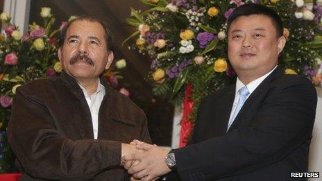 Daniel Ortega (left) and Wang Jing