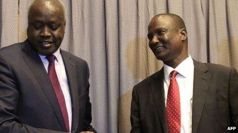 South Sudanese rebel delegation chief Taban Deng (R) shakes hands with South Sudanese leader of the government's delegation Nial Deng Nial