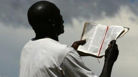 A man in Malawi reads from a bible