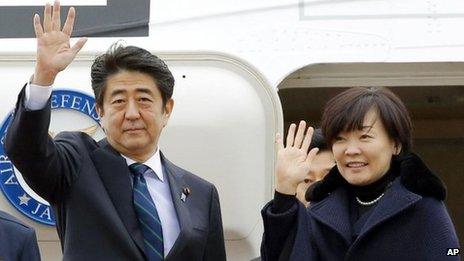 Japanese Prime Minister Shinzo Abe, center, and his wife Akie wave as they depart for Africa, at Haneda Airport in Tokyo Thursday, Jan. 9, 2014.