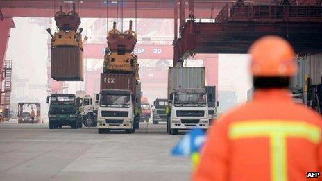 Containers are transported in a port in Qingdao, east China"s Shandong province