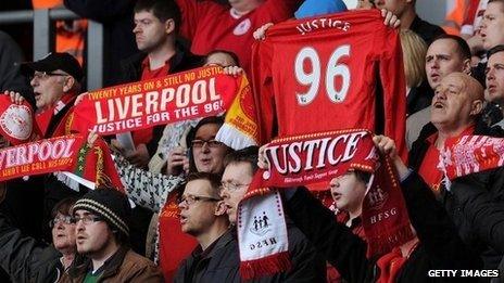 Liverpool fans holding Hillsborough scarves