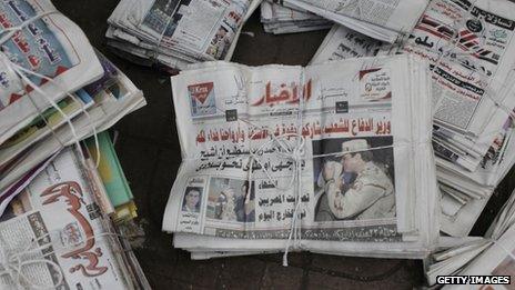 An Egyptian newspaper shows a picture of Defence Minister General Abdul Fattah al-Sisi near a polling booth in the district of Zamalek on January 14, 2014 in Cairo, Egypt.