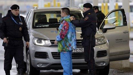 Russian police search a driver and his vehicle at the entrance to the Sochi Olympic park. Photo: 23 January 2014