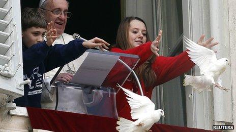 Pope Francis watches as two children release the doves during the Angelus prayer in Saint Peter's Square at the Vatican