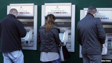 People using Lloyds Bank cash machines