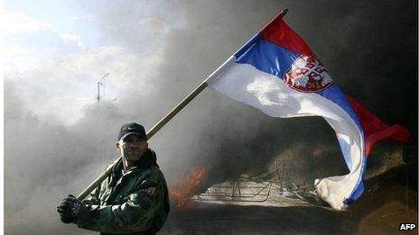 A Serbian protester waves the Serbian flag at Merdare border point between Kosovo and Serbia, a neutral zone 40 km from Pristina, on 21 February 2008