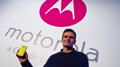 CEO in front of motorola sign