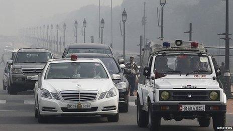 A government vehicle with a red light atop is driven along a road in New Delhi January 8, 2014.