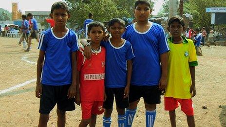 Football hopefuls. Slum kids in football strip