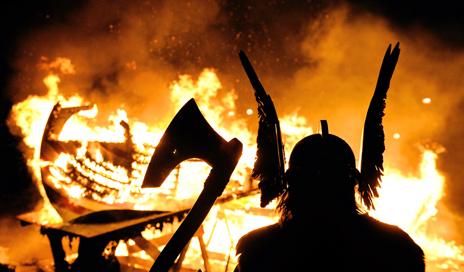 Man dressed up as viking at boat burning