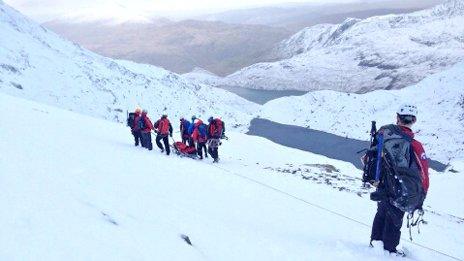 Aberglaslyn Mountain Rescue Team move the man down the mountain