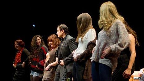 John Travolta teaches audience members to dance