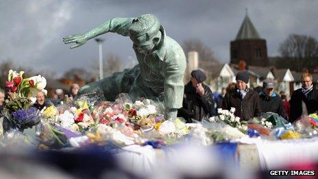 Mourners at the statue of Sir Tom Finney