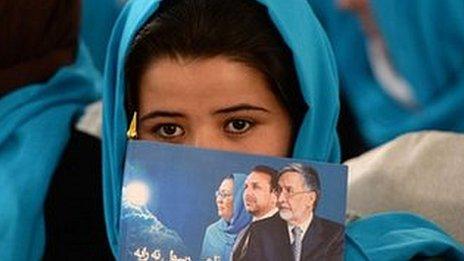 A supporter of holds of Afghan vice-presidential candidate Habiba Surabi hold her picture