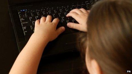 Child using a computer (posed by model)