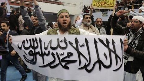 A protester holds up a sign at the rally on 21 March calling for the boycott of the Algerian presidential election