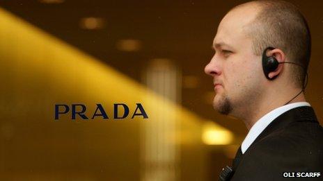 Prada sign and security man
