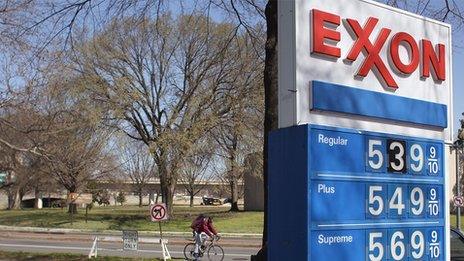 Exxon sign with man biking in the background