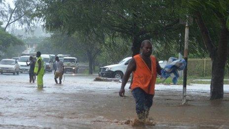 A man walks through flood waters in the Solomon Islands capital of Honiara on 4 April 2014.