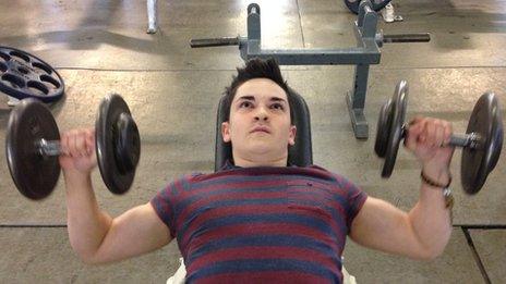 Young man lifting weights
