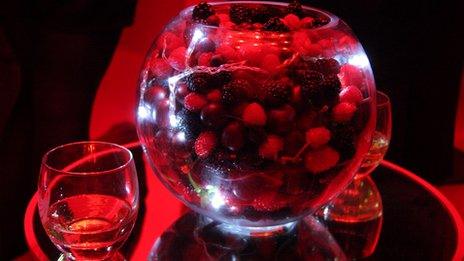 fruit and whisky glasses in red light
