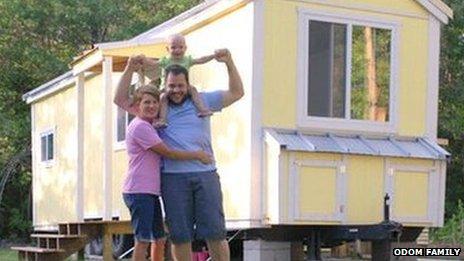 Andrew Odom, shown with his wife, Crystal, and daughter, in front of their tiny house