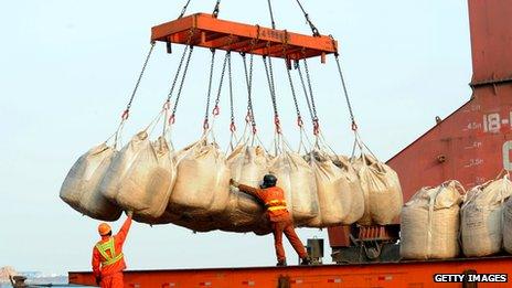 Workers unload goods from a ship at Lianyungang, China, in Feb 2014