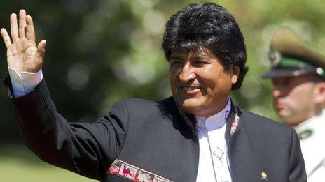 Bolivia's President Evo Morales waves at the press in Chile on March 11, 2014.
