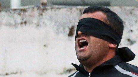 Balal, who killed Iranian youth Abdollah Hosseinzadeh in a street fight with a knife in 2007, reacts as he stands in the gallows during his execution ceremony in the northern city of Nowshahr on 15 April 2014