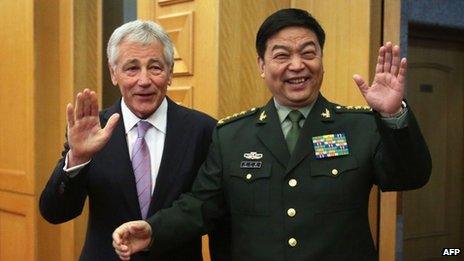 US Defense Secretary Chuck Hagel (L) and Chinese Minister of Defense Chang Wanquan gesture to members of the media prior to their meeting at the Chinese Defense Ministry headquarters in Beijing on April 8, 2014.