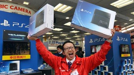 Salesman holding PS4 boxes