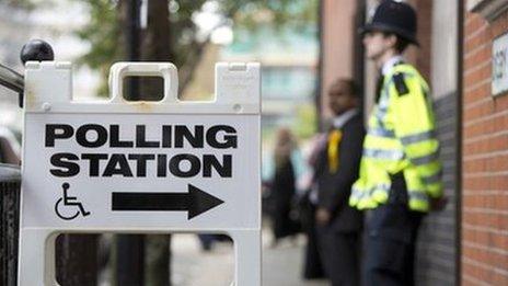 A police officer stands outside a polling station in Tower Hamlets