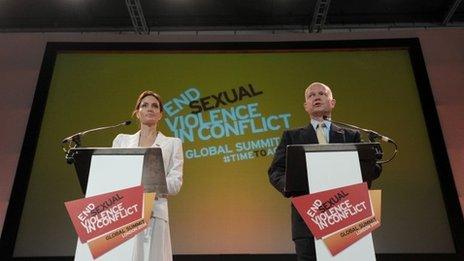 Britain's Foreign Secretary William Hague and US actress and UN special envoy Angelina Jolie make their opening speeches at the four-day Global Summit to End Sexual Violence in Conflict in east London on 10 June 2014.