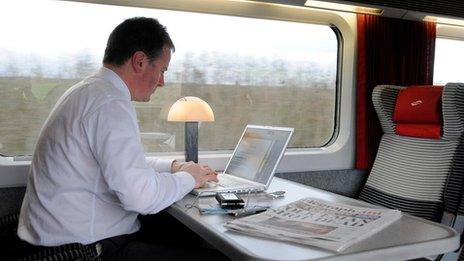 Businessman using computer on a train