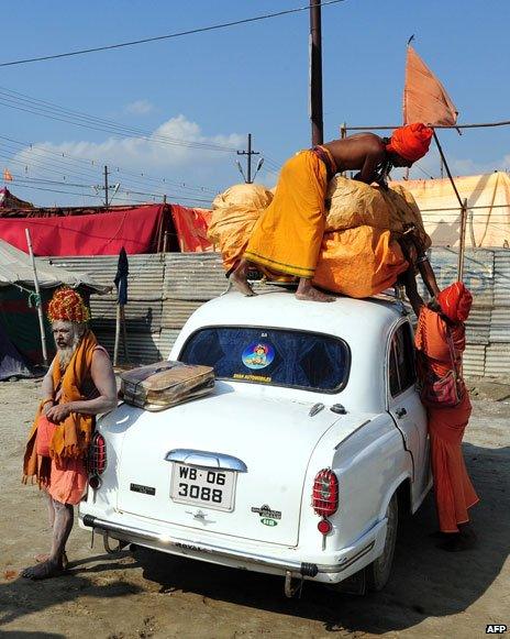 Sturdy workhorse: holy men climbing on the Ambassador's roof