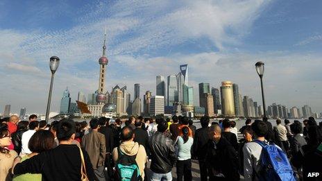 People looking at Pudong financial district in Shanghai