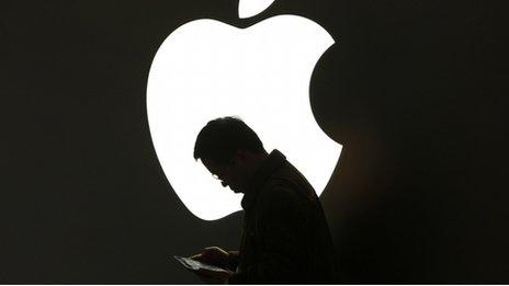 Man in front of Apple logo