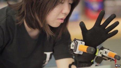 MIT researcher with robotic hand