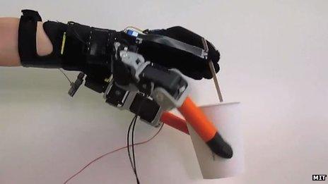 Robotic hand holding coffee cup