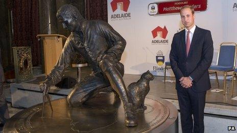 Prince William looks at a statute in honour of Captain Matthew Flinders