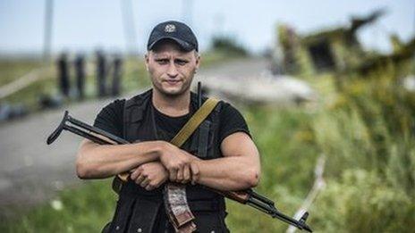 A pro-Russian fighter guarding the crash site