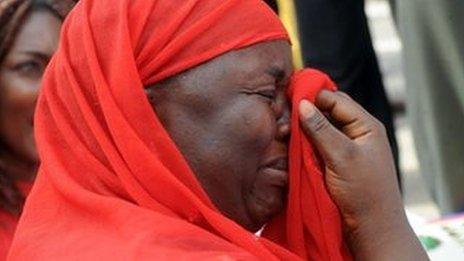 One of the mothers of the missing Chibok school girls wipes her tears as she cries during a rally by civil society groups pressing for the release of the girls in Abuja on 6 May 2014