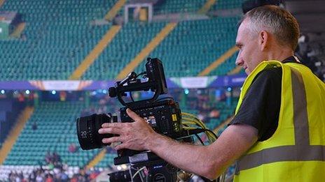 A BBC R&D engineer sets up one of the UHD cameras at a games venue