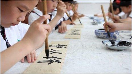 TV still of Beijing children practising Chinese calligraphy